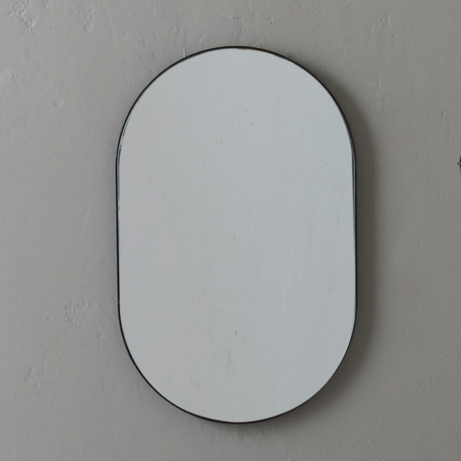 specchio ovale con fascia in metall Cor Ten